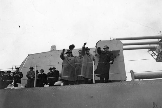 Nikolai Bulganin and Nikita Khrushchev, Soviet politicians, wave from the deck of the cruiser 'Ordzhonikidze' as they leave Portsmouth following a 10-day visit to Britain.  With them are Russian aeronautical designer Andrei  Nikolaevich Tupolev, and atomic chief, Dr Igor Kurchatov, 2nd left.    (Photo by Folb/Getty Images)