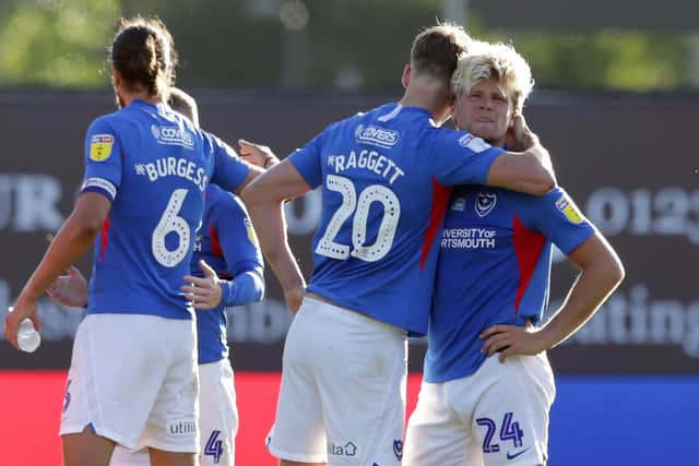 Sean Raggett consoles Cameron McGeehan after his missed penalty against Oxford. Picture: Robin Jones/Getty Images