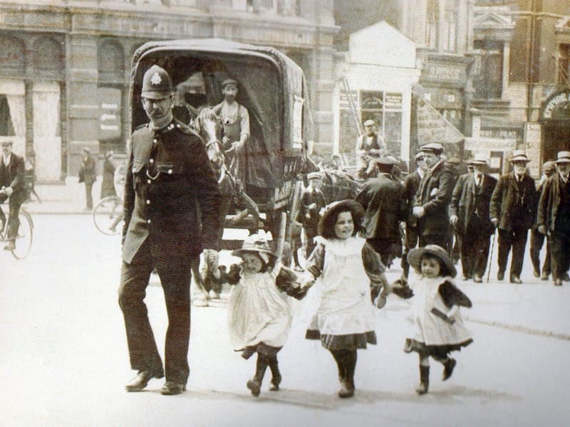 Crossing Commercial Road at the junction with Edinburgh Road, but where are the girls parents?