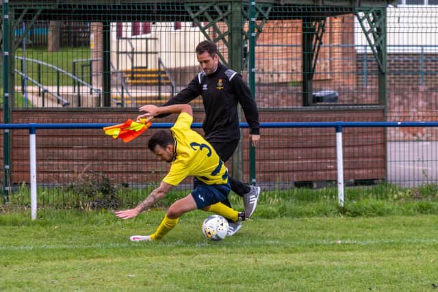 Paulsgrove's Preston Tee collides with Fleetlands boss Rich Bessey, who was running the line for his side in the first half. Picture: Mike Cooter