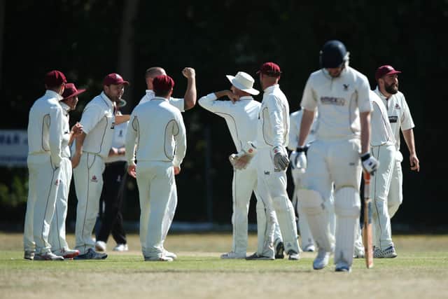 Portsmouth & Southsea celebrate a wicket against Purbook with elbow bumps rather than high fives. Picture: Chris Moorhouse
