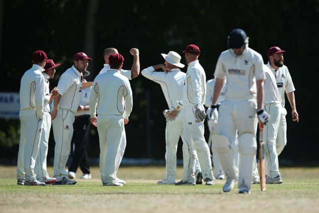 Portsmouth & Southsea celebrate a wicket against Purbook with elbow bumps rather than high fives. Picture: Chris Moorhouse