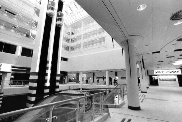 The glass lifts from the carpark lead down to the main shopping level and food court, pictured here in September 1989