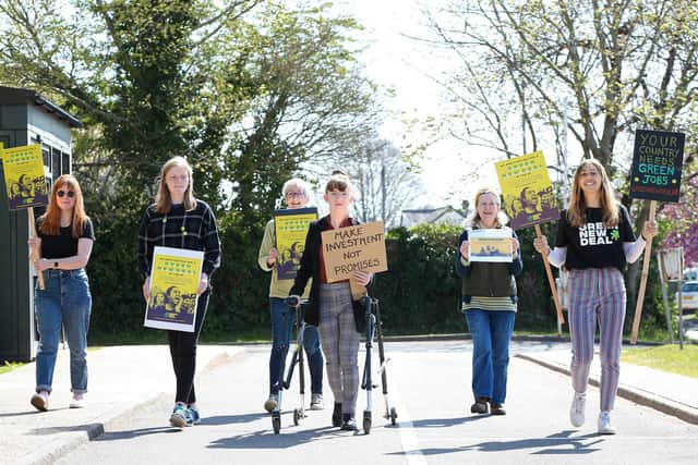 Campaigners, from left, Izzy Fletcher, Susie Caston, Margaret Lockyer, Keira Power, Philippa Gray and Lisa Bruni, queue outside the Job Centre. Picture: Chris Moorhouse