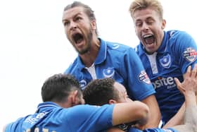 Adam Webster (right) and Christian Burgess mob Matt Tubbs (unsighted) after scoring at Cambridge United in October 2015. Picture: Joe Pepler