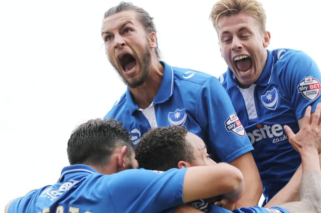 Adam Webster (right) and Christian Burgess mob Matt Tubbs (unsighted) after scoring at Cambridge United in October 2015. Picture: Joe Pepler