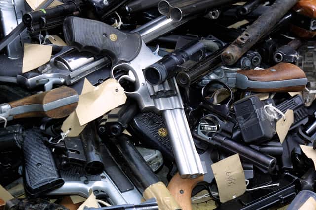 Guns taken out of circulation and to be destroyed by putting them into a metal shredder called the Euro-Shear Machine which cuts the guns into pieces, viewed during a  Scotland Yard photocall in London