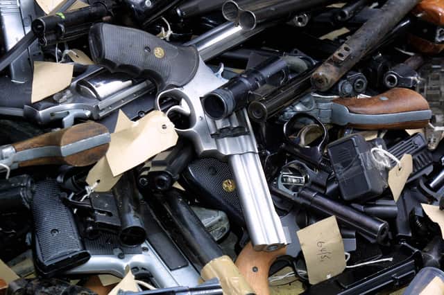 Guns taken out of circulation and to be destroyed by putting them into a metal shredder called the Euro-Shear Machine which cuts the guns into pieces, viewed during a Scotland Yard photocall in London