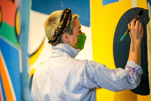Painting the mural in the Sadler Gallery. Picture: James White photography