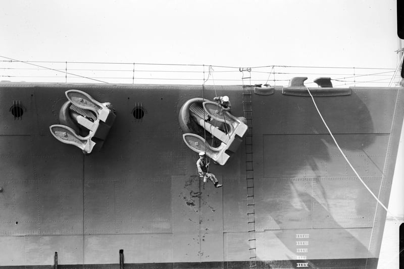 Painting the battleship HMS Nelson April 1929: Sailors painting the anchor on the HMS Nelson. (Photo by Fox Photos/Getty Images)