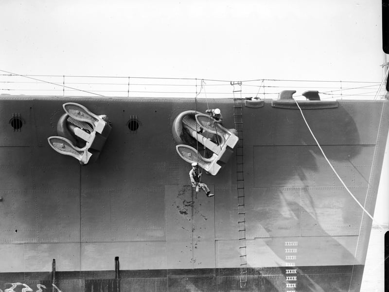 Painting the battleship HMS Nelson April 1929: Sailors painting the anchor on the HMS Nelson. (Photo by Fox Photos/Getty Images)