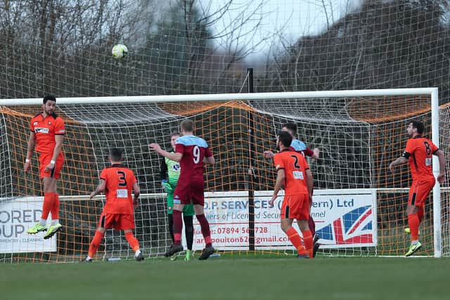Recent defensive recruit Jordan Rose heads clear for AFC Portchester against Hamworthy. Picture: Chris Moorhouse