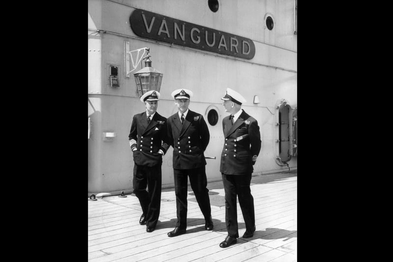 31st May 1960:  Flag Captain and senior officer Captain NW Fisher, Rear Admiral J Grant and Commander JA Brooke standing on the deck of HMS Vanguard, Britain's largest warship.  (Photo by Dennis Oulds/Central Press/Getty Images)