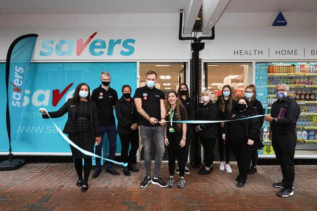 Manager Reece Webber cuts the ribbon, backed by the staff. Opening of Savers, High St, Gosport
Picture: Chris Moorhouse (jpns 180621-01)
