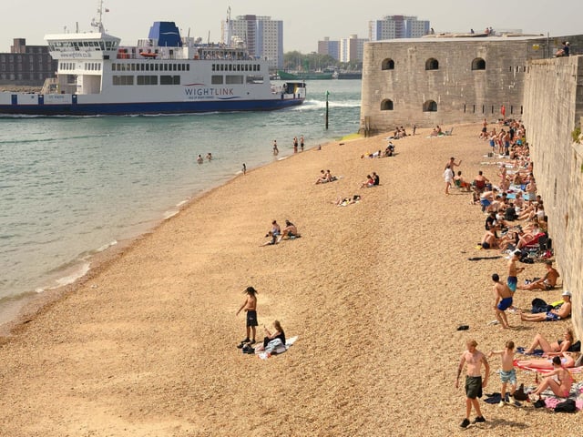 Pictured is: Sun worshippers enjoying the Hotwall's in Old Portsmouth.