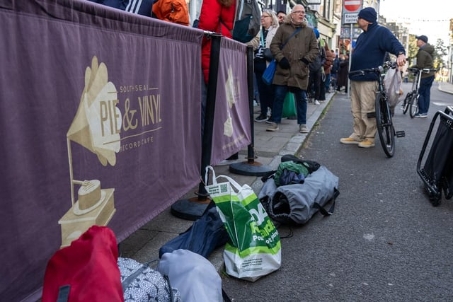 A group of people queuing outside Pie and Vinyl with tents