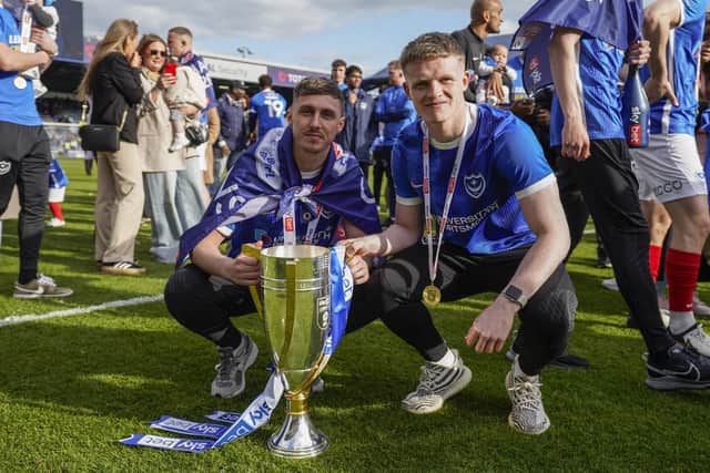 Gavin Whyte, left, celebrates Pompey’s League One title success with former team-mate Terry Devlin