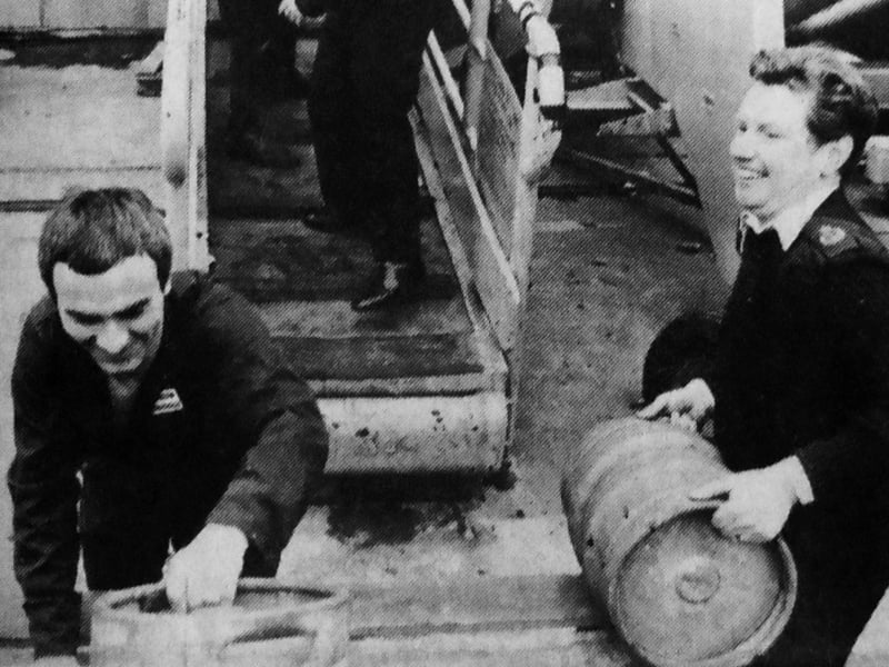 Kegs of beer are cheerfully manhandled aboard HMS Hermes in preparation for the departure for the Falkland Islands