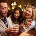 A group of friends enjoying an evening at the pub. Pictured posed before the coronavirus pandemic by models. Photo: Shutterstock