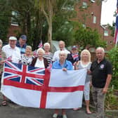 Former veterans and Trafalgar Court residents are angry at having to take down their White Ensign flag. Joe Ince, 76, is far left.