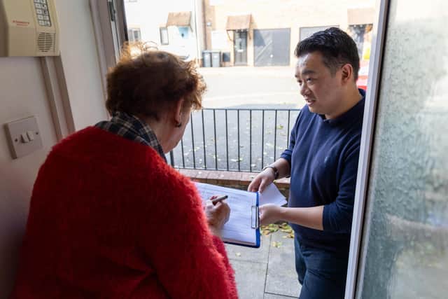 Alan Mak MP talks to a pensioner in Emsworth as she signs his petition to restore the Winter Fuel Payment