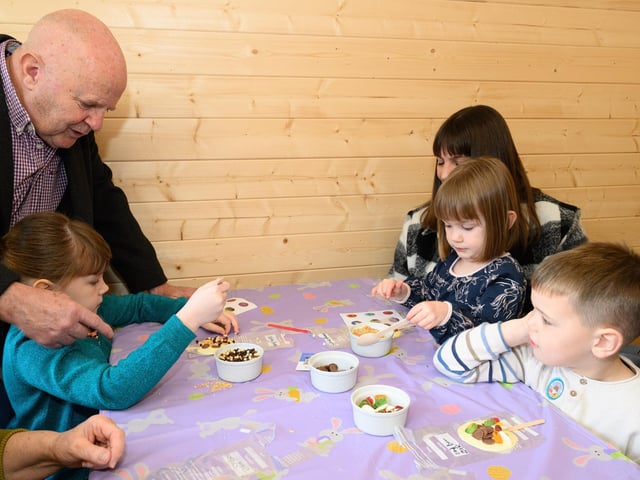 Pictured is: Nancy, Slyly and Zak Burn get help make their Easter Lollipops.Picture: Keith Woodland (300321-3)