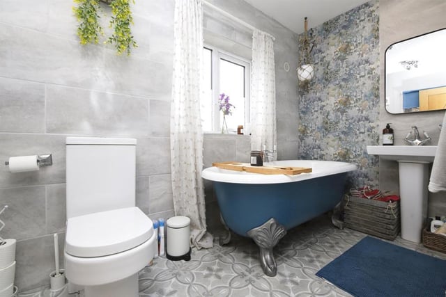 The stylish family bathroom features a free standing bath.