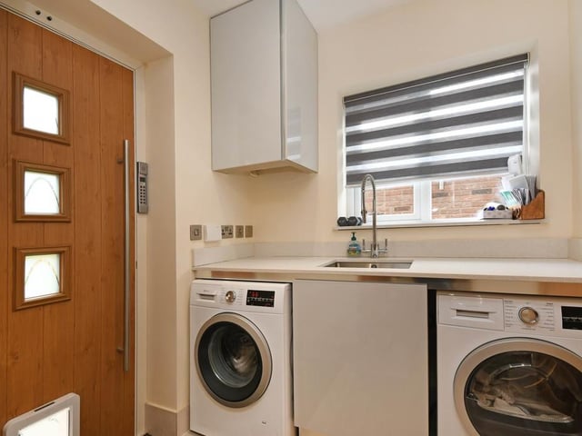Off the kitchen is a laundry room with cupboards and work-top in the same finish as the kitchen, with sink and drainer and space for both a washing machine and a dryer. There is also an additional ground floor w/c and a rear door with access to the rear garden.