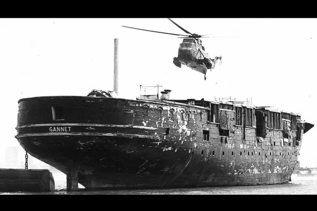 HMS Gannet before restoration moored up Fareham Creek. The helicopter is a brand new Sea King which simulated a landing before flying off to Prestwick in Scotland.