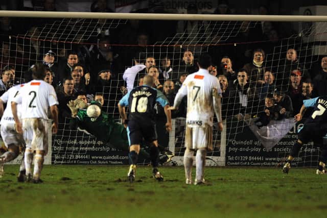 Kevin Scriven dives to his right to save Leon Britton's penalty. Pic: Steve Reid.