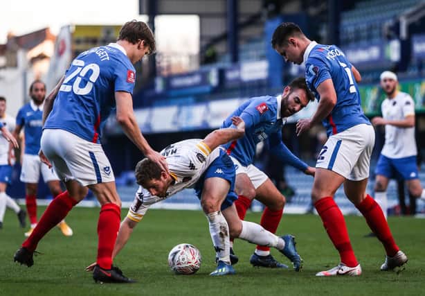 King's Lynn's Adam Marriott can find no way through Pompey - and it was a familiar fate for his team-mates in a 6-1 defeat at Fratton Park. Picture: Kieran Cleeves