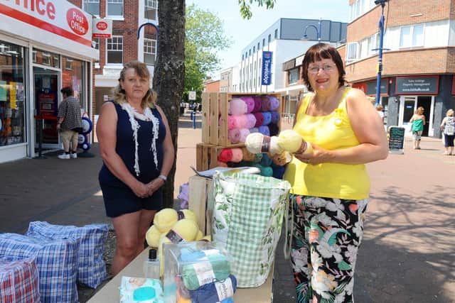 Gosport Market reopened in the High Street on Tuesday, June 2. 

Pictured is: (l-r) Nikki Eastland from Giddy Goat Yarns and Accessories serving Tandy Powell.

Picture: Sarah Standing (020620-9443)