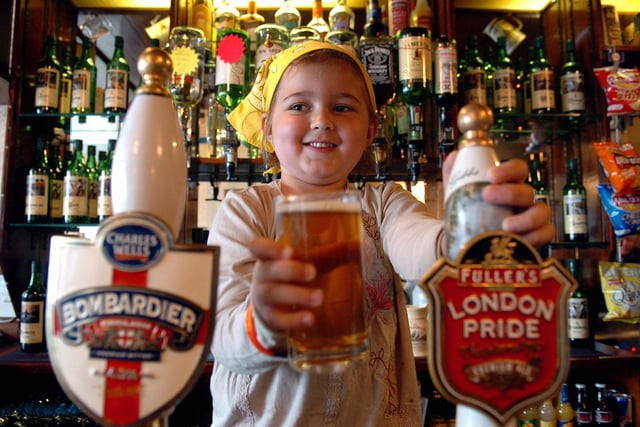 Five-year-old Hannah Johnson behind the bar of the Milton Road pub during a charity day for ClicSargent (064221-177)