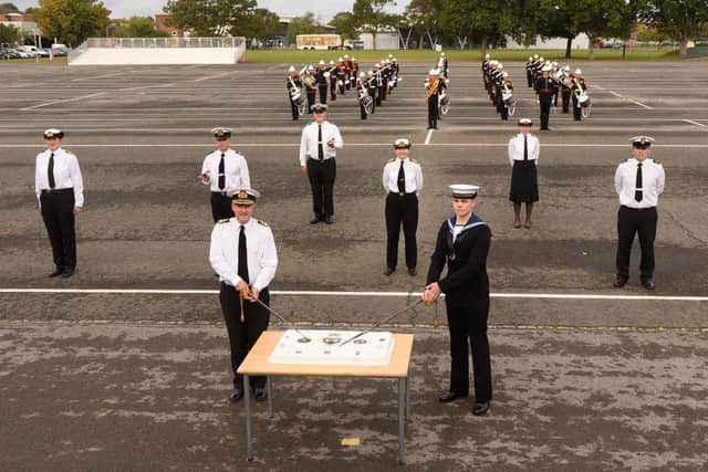 Rear Admiral Hally and ET Overal cutting the cake. Photo: Keith Woodland