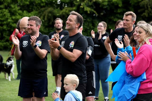 The relay runners are clapped to the finishing line.
Picture: Sam Stephenson.