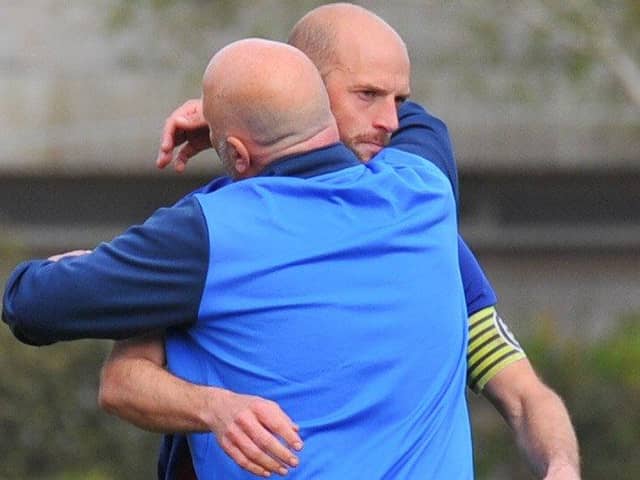 Tom Jeffes gets a consoling hug from boss Glenn Turnbull after US Portsmouth's cruel penalty shoot-out loss to Binfield in the semi-final of the FA Vase. Picture: Martyn White.