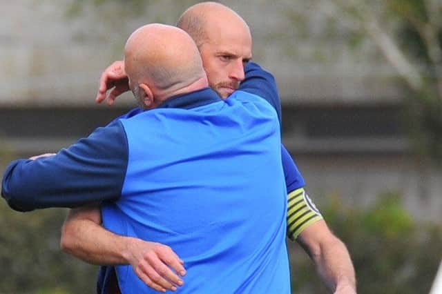 Tom Jeffes gets a consoling hug from boss Glenn Turnbull after US Portsmouth's cruel penalty shoot-out loss to Binfield in the semi-final of the FA Vase. Picture: Martyn White.