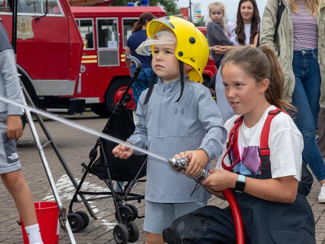 Teddy Tupper, 3, tries his hand at the hose at Port Solent 999 Day.  Photos by Alex Shute