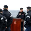 Commander George Storton reminds HMS Dragon's sailors of HMS Ark Royals achievements and sacrifices