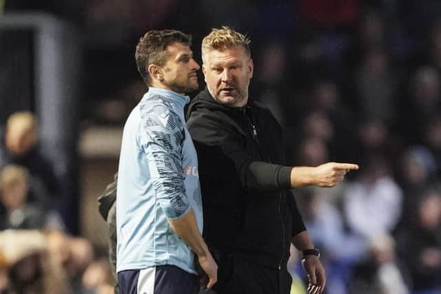 Oxford United boss Karl Robinson has branded Sam Purkiss' officiating an 'embarrassment' against Pompey.