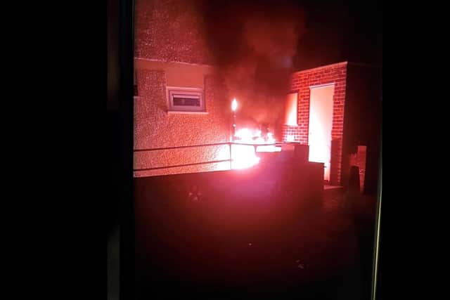 Nearby residents report hearing a loud bang before seeing flames engulf the property's front door.
