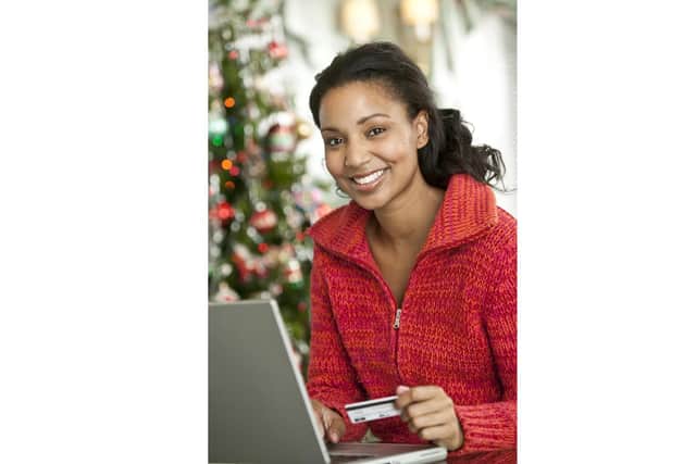 A woman doing her Christmas shopping online Picture posed by model
