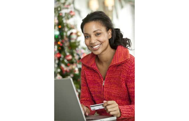 A woman doing her Christmas shopping online Picture posed by model