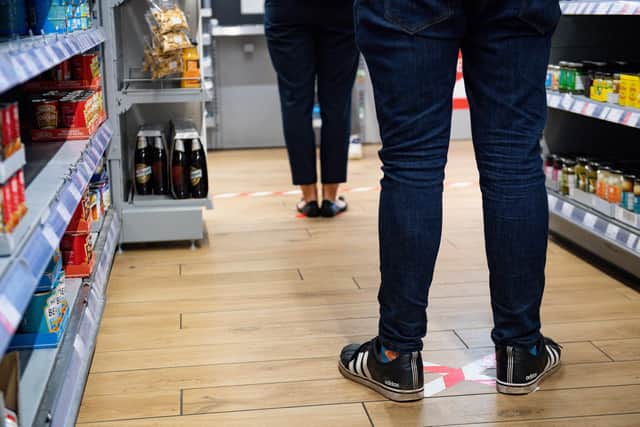 Social distancing and other coronavirus precautions at a Co-op. Pic: Jacob King/PA Wire.