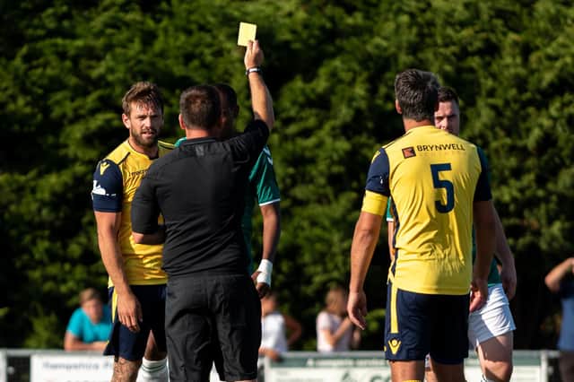 Steve Hutchings, left, picked up a booking against Bashley but boss Glenn Turnbull saluted his discipline. Picture: Vernon Nash
