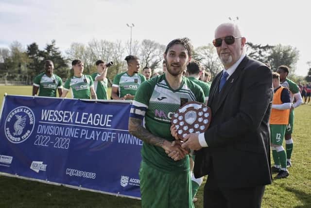 Petersfield skipper Connor Hoare is presented with the Wessex League Division 1 play-off final silverware. Picture by Robin Caddy