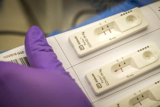 A researcher compares the results of a rapid corona test and a normal one during a trial. Picture: Lex van LIESHOUT / ANP / AFP) / Netherlands OUT (Photo by LEX VAN LIESHOUT/ANP/AFP via Getty Images)