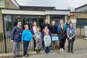Councillor Dave Ashmore (centre left), Cllr Matthew Winnington and playground deputy leader, John Hale (blue jumper), alongside playground staff and children at the unveiling of a second sign at Paulsgrove Community Centre.