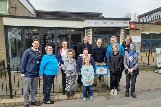 Councillor Dave Ashmore (centre left), Cllr Matthew Winnington and playground deputy leader, John Hale (blue jumper), alongside playground staff and children at the unveiling of a second sign at Paulsgrove Community Centre.