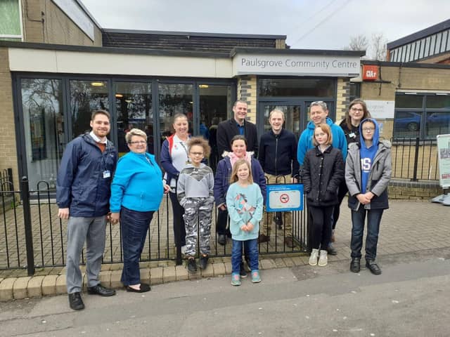 Councillor Dave Ashmore (centre left), Cllr Matthew Winnington and playground deputy leader, John Hale (blue jumper), alongside playground staff and children at the unveiling of a second sign at Paulsgrove Community Centre.
